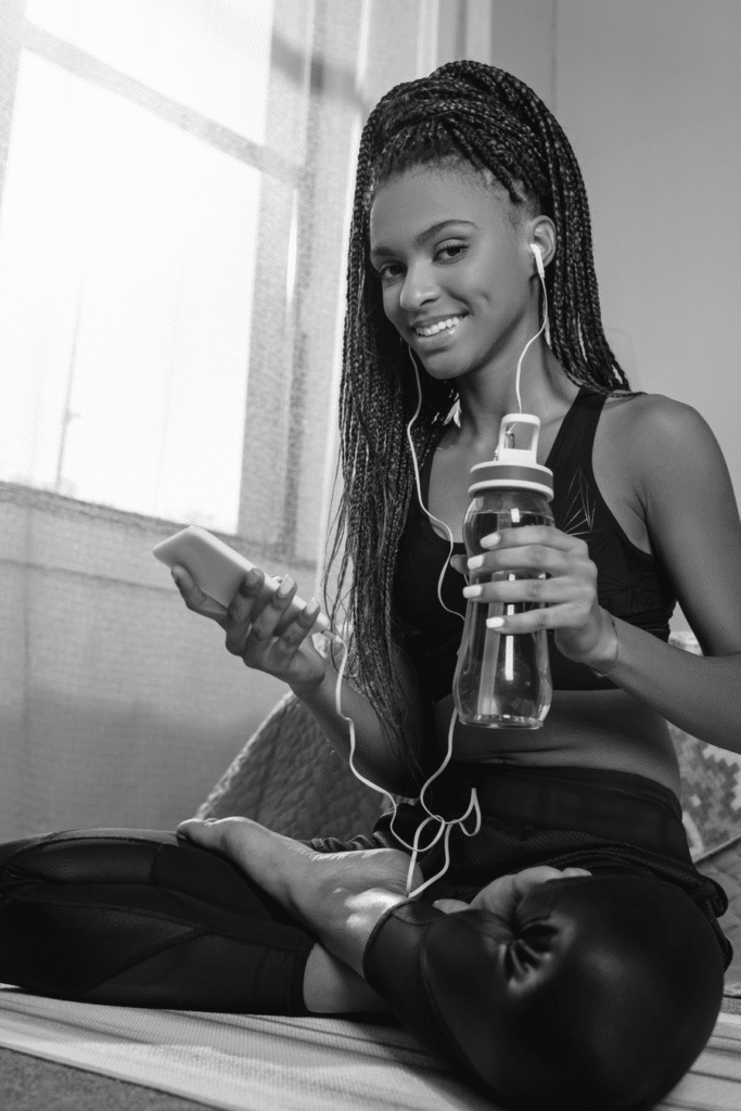 woman with water bottle and in workout clothes